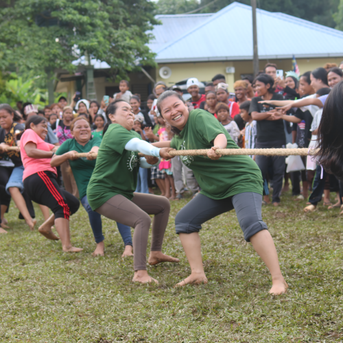 Women from the villages show strength and unity in the tug of war.