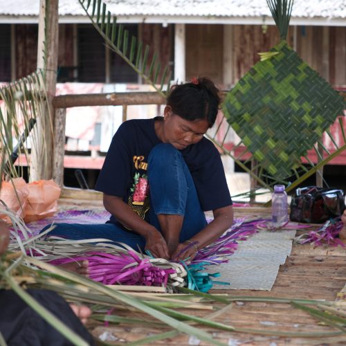 Jakun Indigenous women preserving traditional weaving using natural materials.